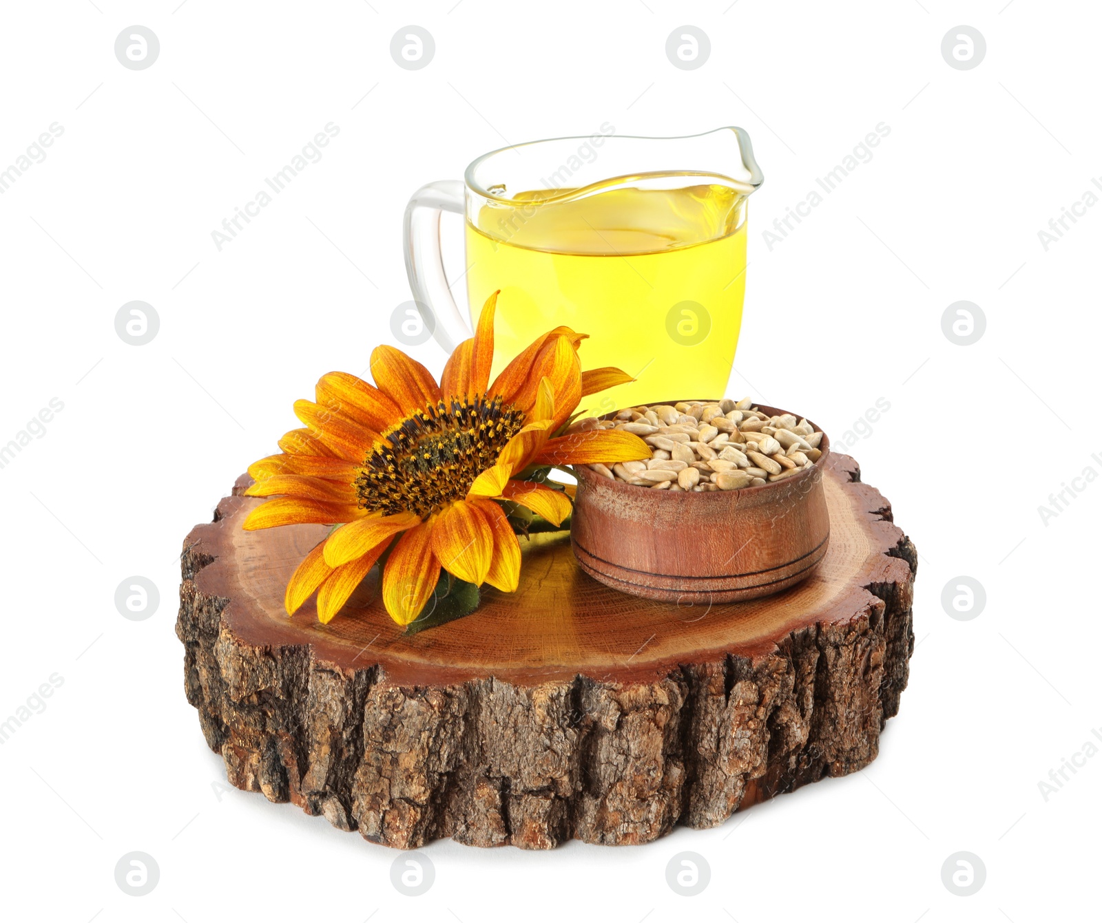 Photo of Sunflower, jug of oil and seeds on white background