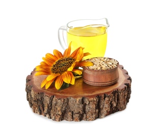 Photo of Sunflower, jug of oil and seeds on white background