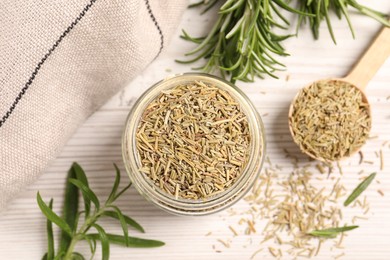 Fresh and dry rosemary on white wooden table, flat lay