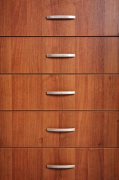 Wooden wardrobe drawers as background, closeup view