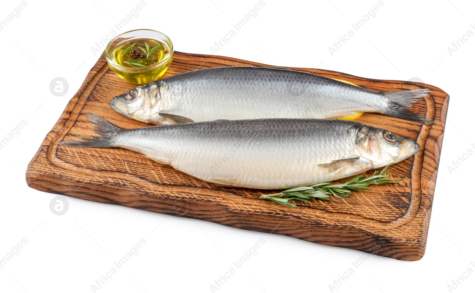 Photo of Wooden board with salted herrings, slices of lemon, oil and rosemary isolated on white