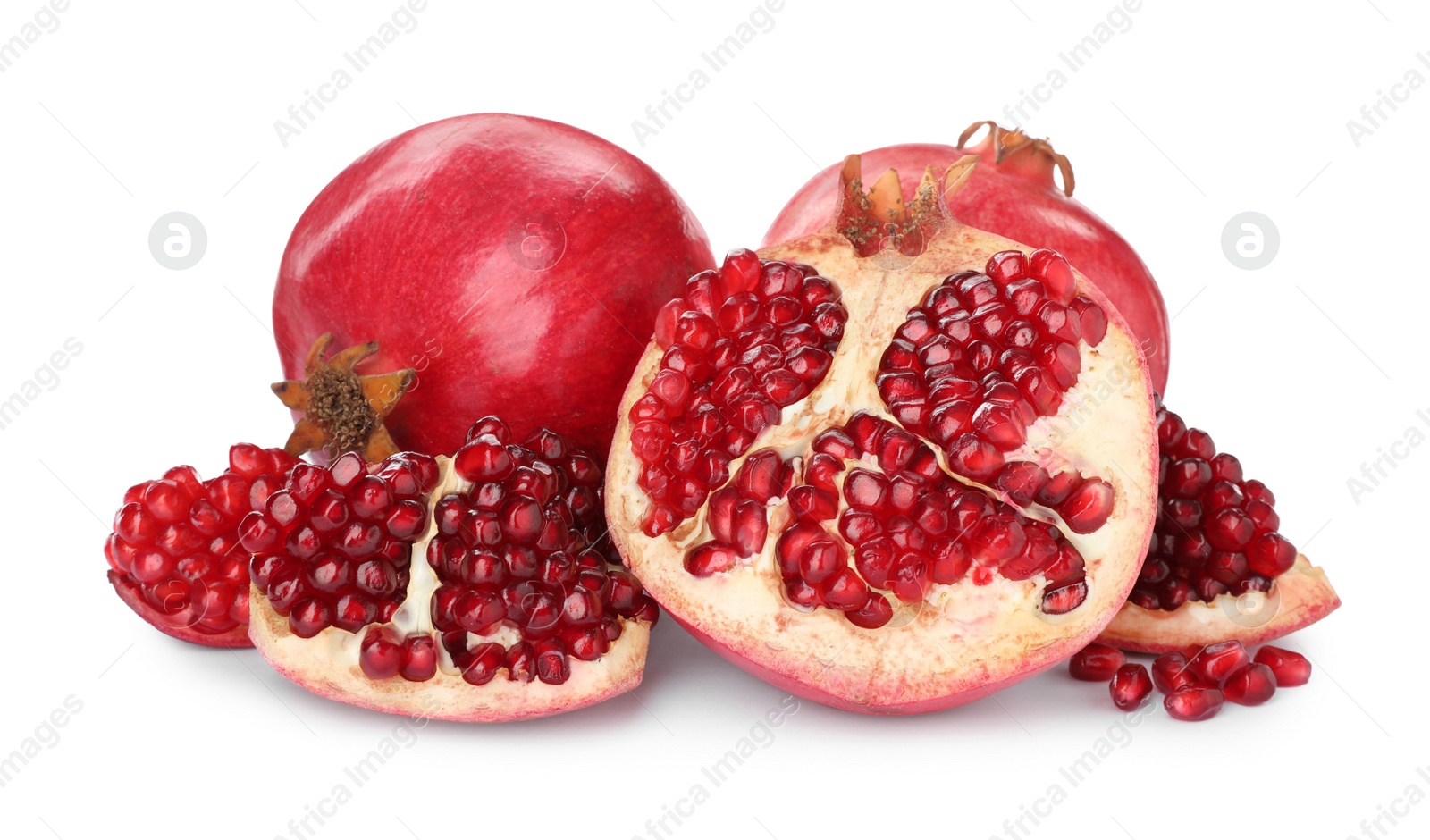 Photo of Tasty ripe pomegranates with juicy seeds on white background