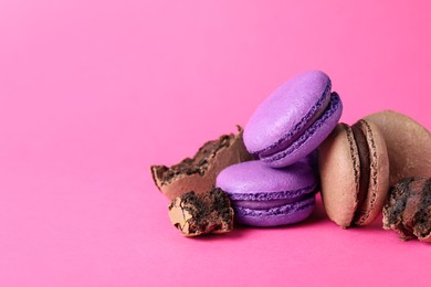 Photo of Pile of delicious colorful macarons on pink background. Space for text