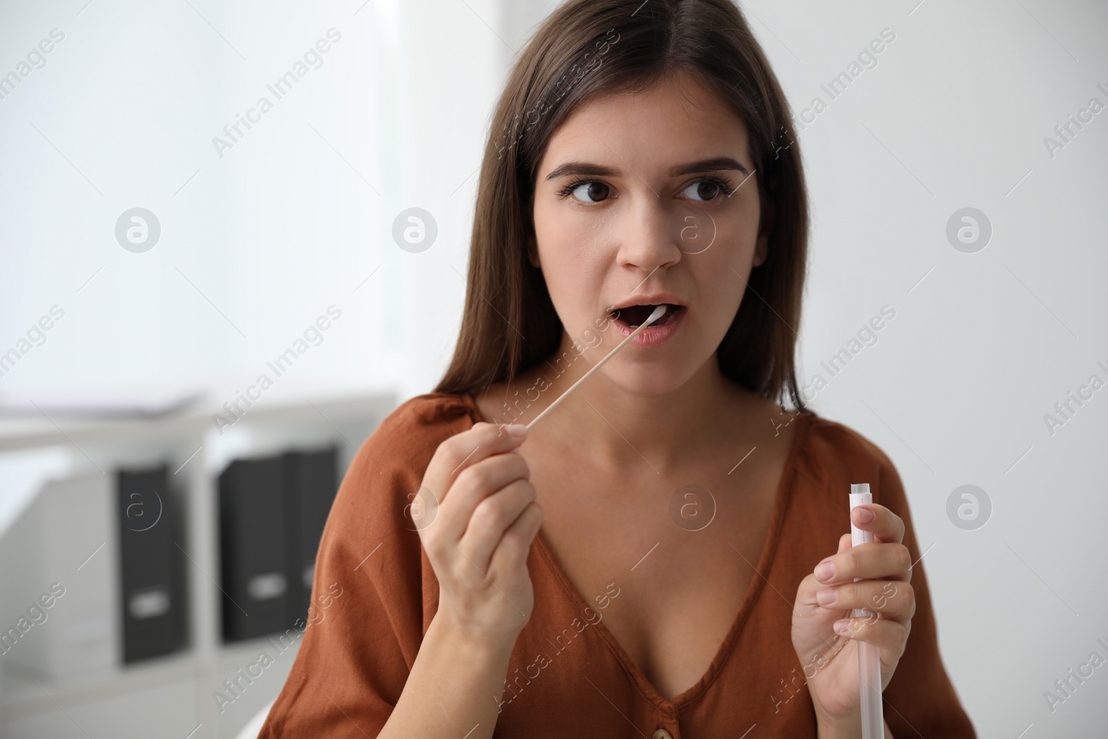 Photo of Woman taking sample for DNA test indoors