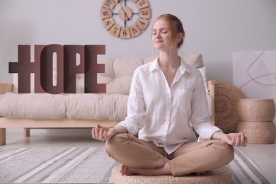 Image of Concept of hope. Woman meditating on wicker mat at home
