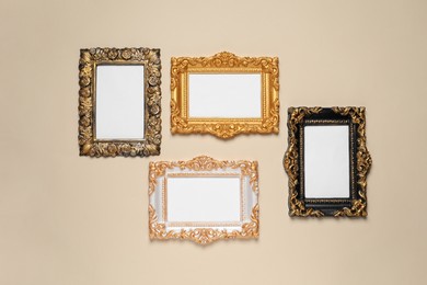 Empty vintage frames hanging on beige wall