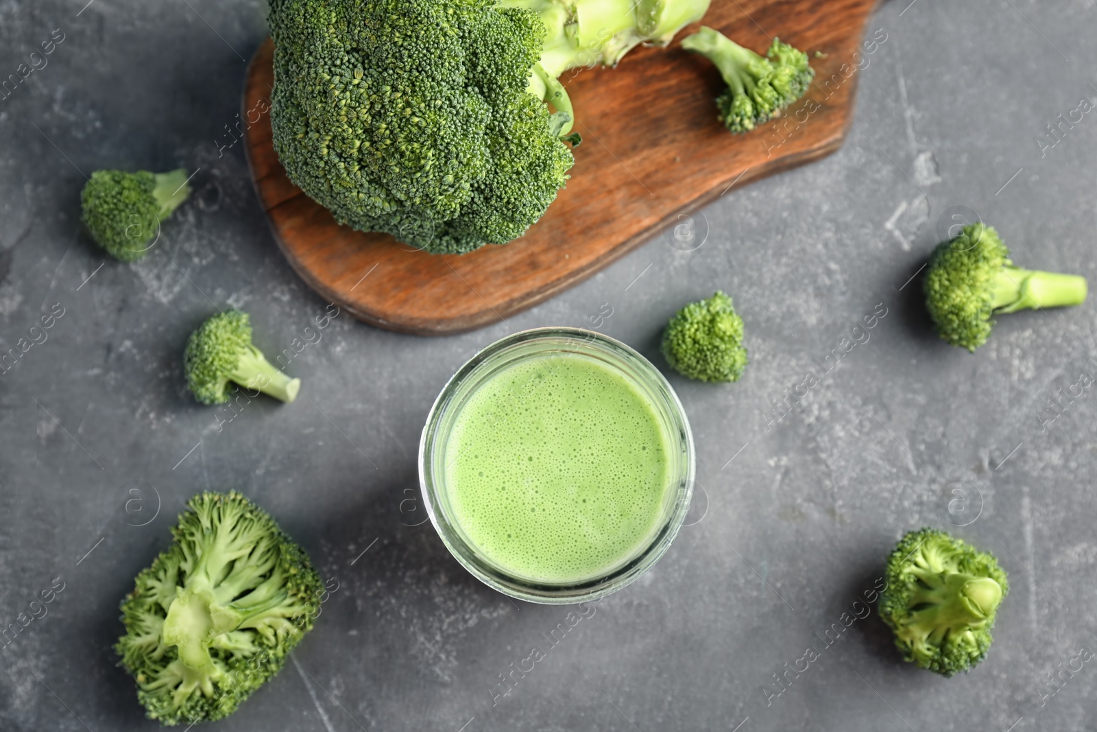 Photo of Flat lay composition with healthy detox smoothie and broccoli on grey background