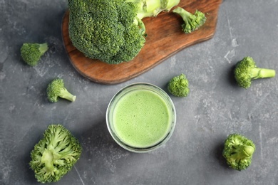 Flat lay composition with healthy detox smoothie and broccoli on grey background