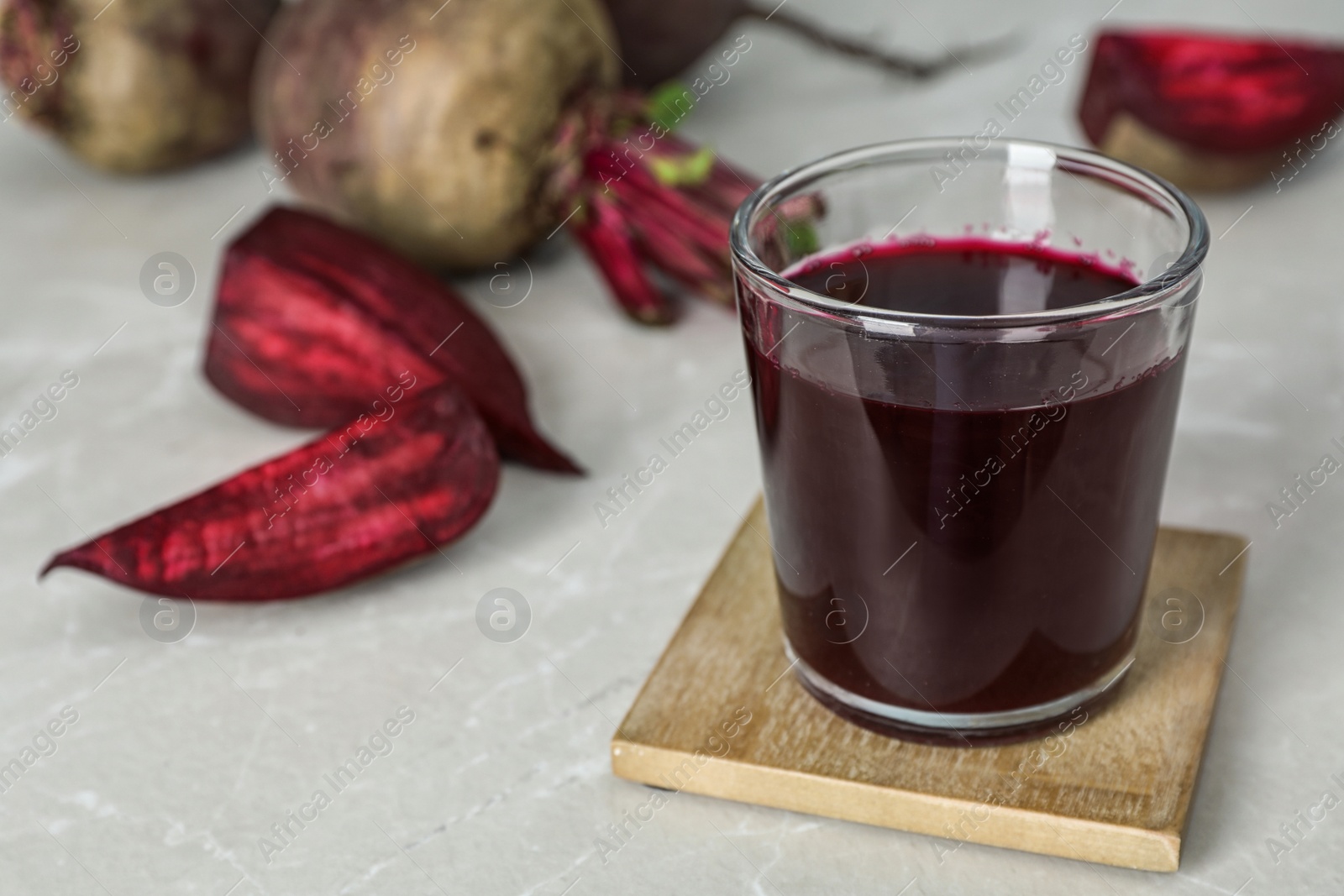 Photo of Glass with fresh healthy beet juice on table