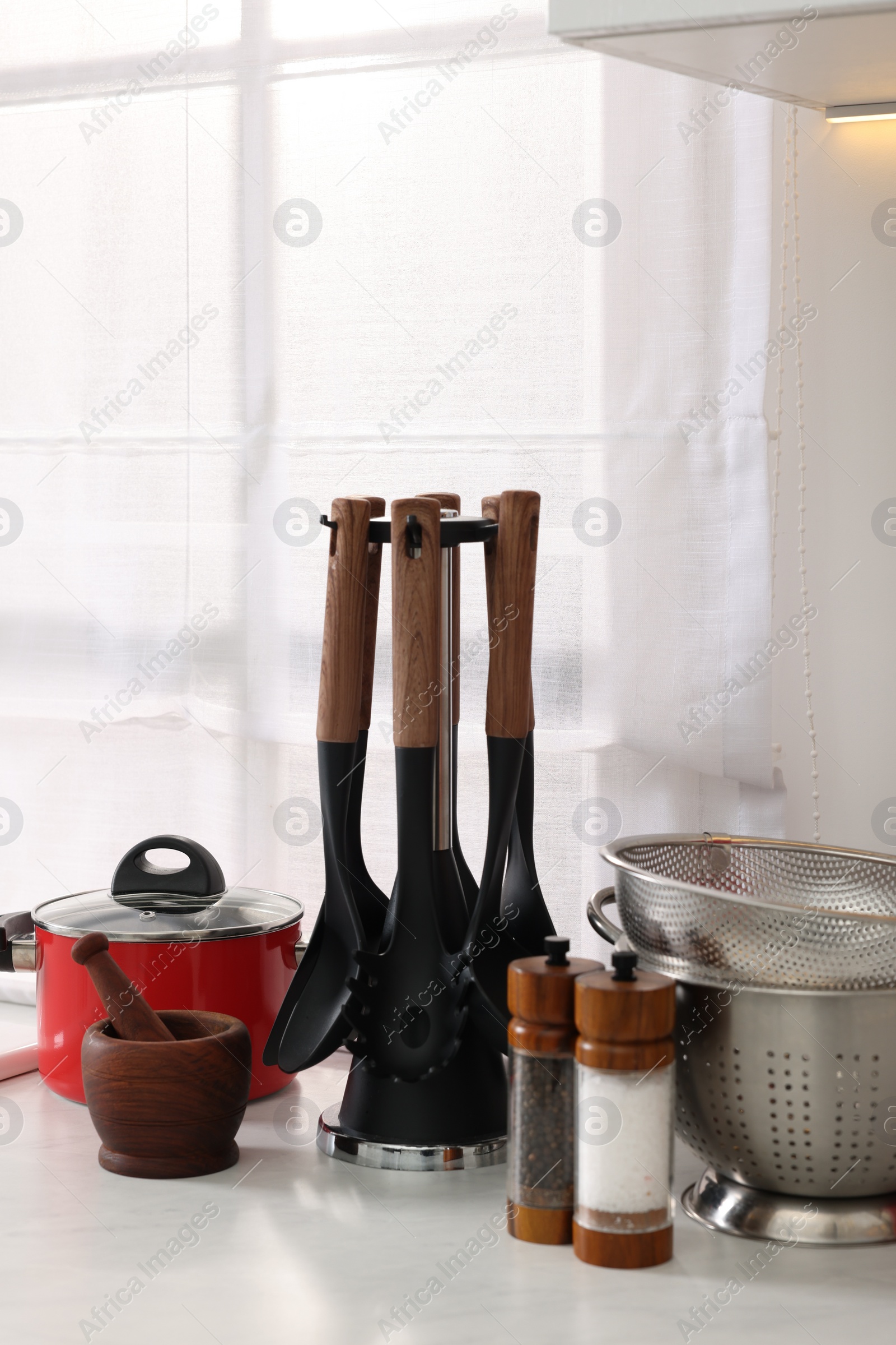 Photo of Set of different utensils on countertop in kitchen