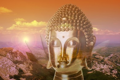 Golden Buddha sculpture and beautiful mountain landscape at sunset 