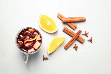 Flat lay composition with cup of hot mulled wine on gray background