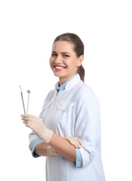 Photo of Female dentist holding professional tools on white background