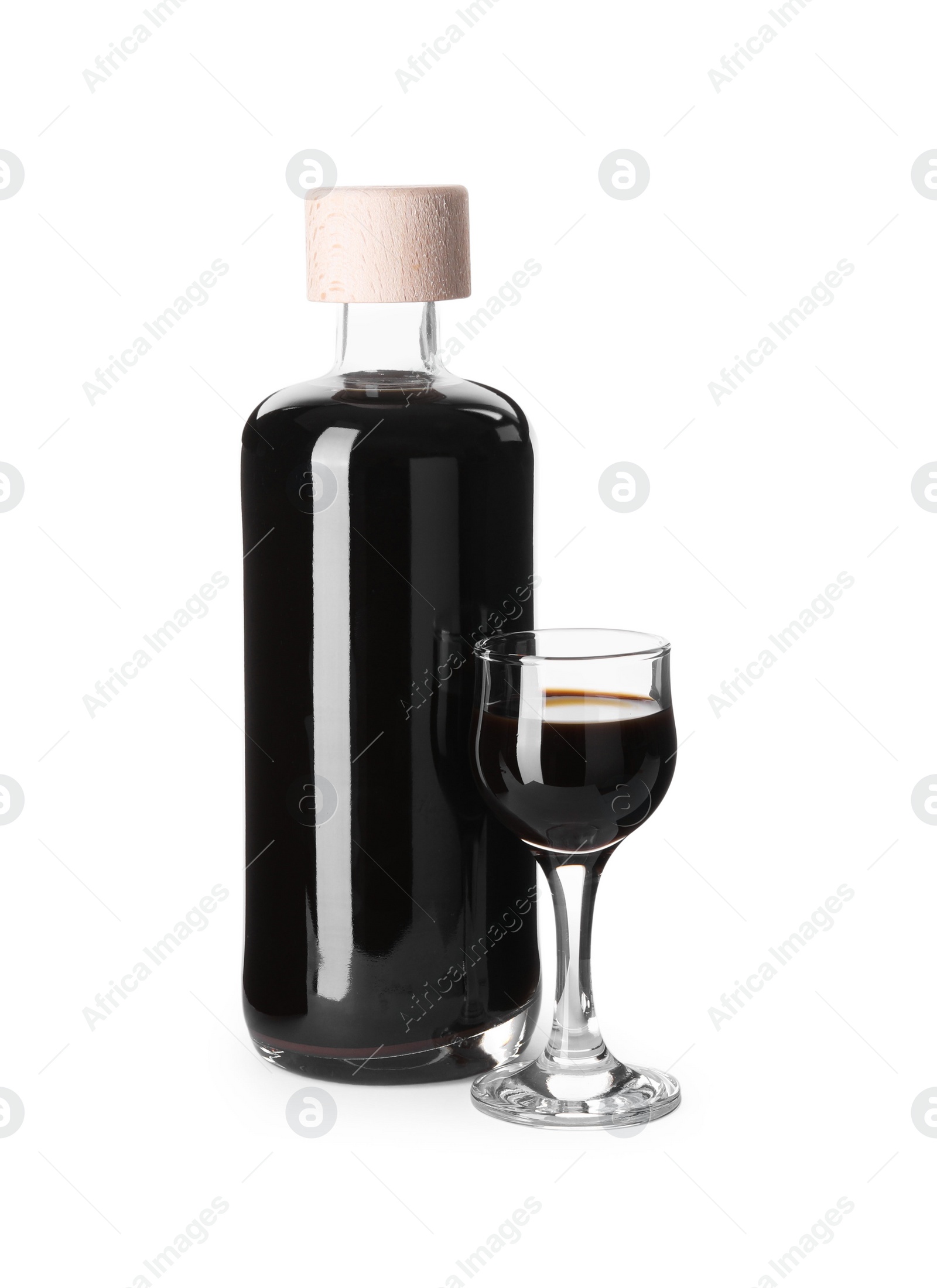 Photo of Bottle and glass with coffee liqueur isolated on white