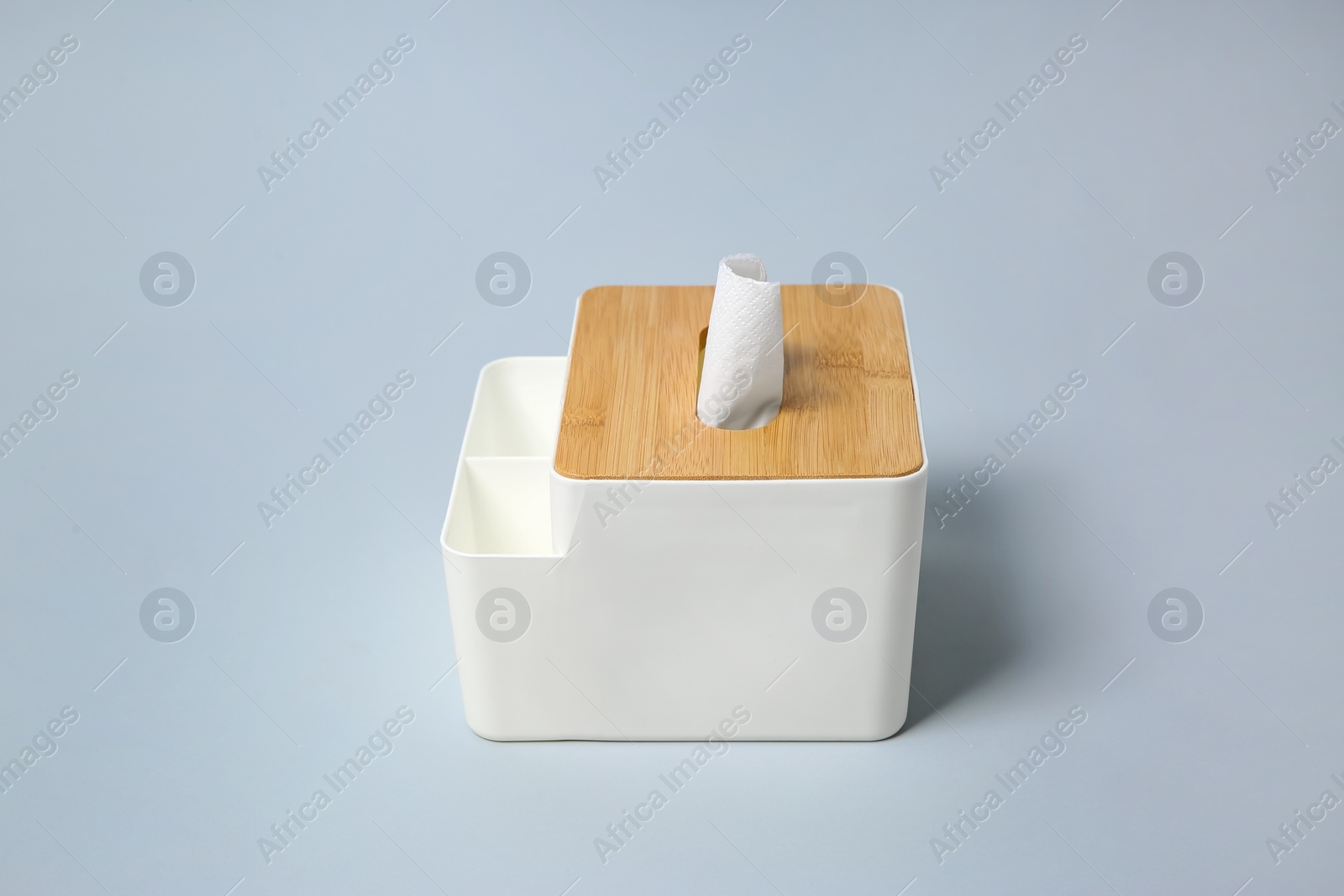 Photo of Holder with paper tissues on light grey background