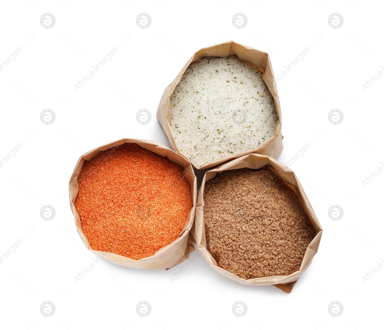 Photo of Different salts in paper bags on white background, top view