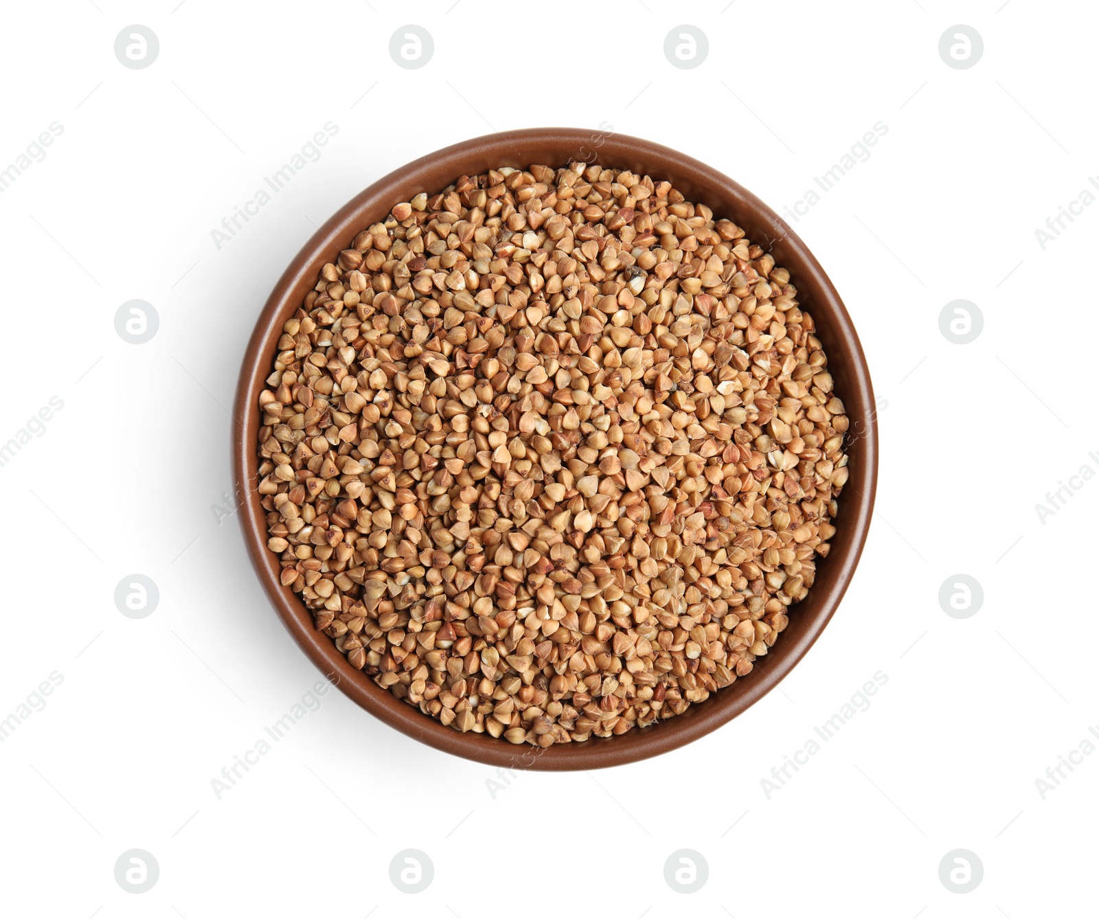 Photo of Bowl with uncooked buckwheat on white background, top view