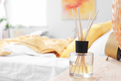 Photo of Reed freshener on table in bedroom