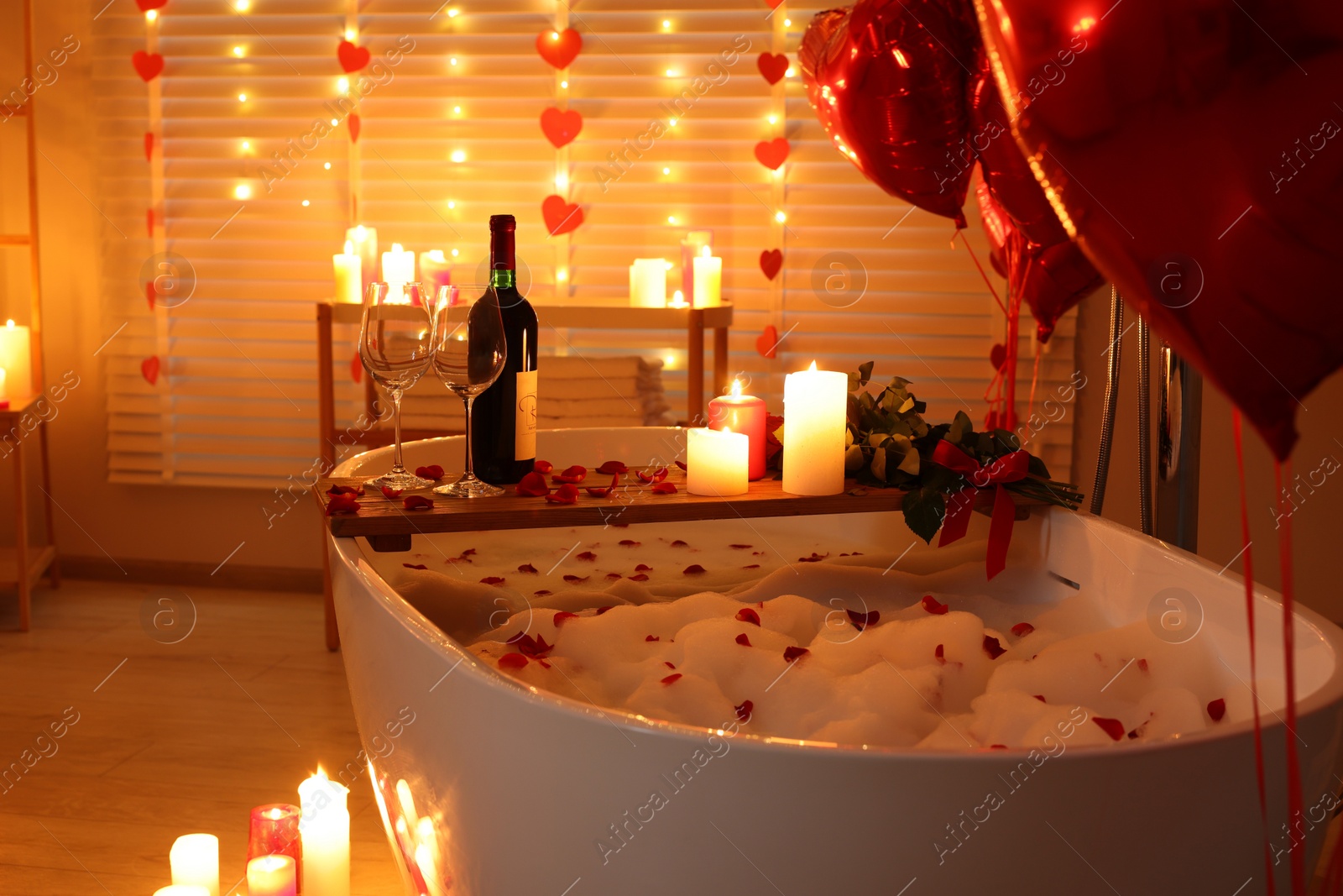 Photo of Stylish bathroom decorated for Valentine's day. Interior design