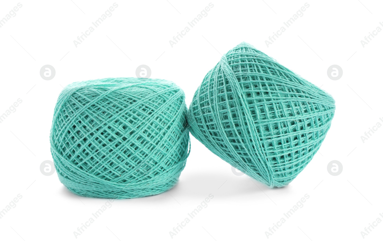Photo of Clews of colorful knitting threads on white background
