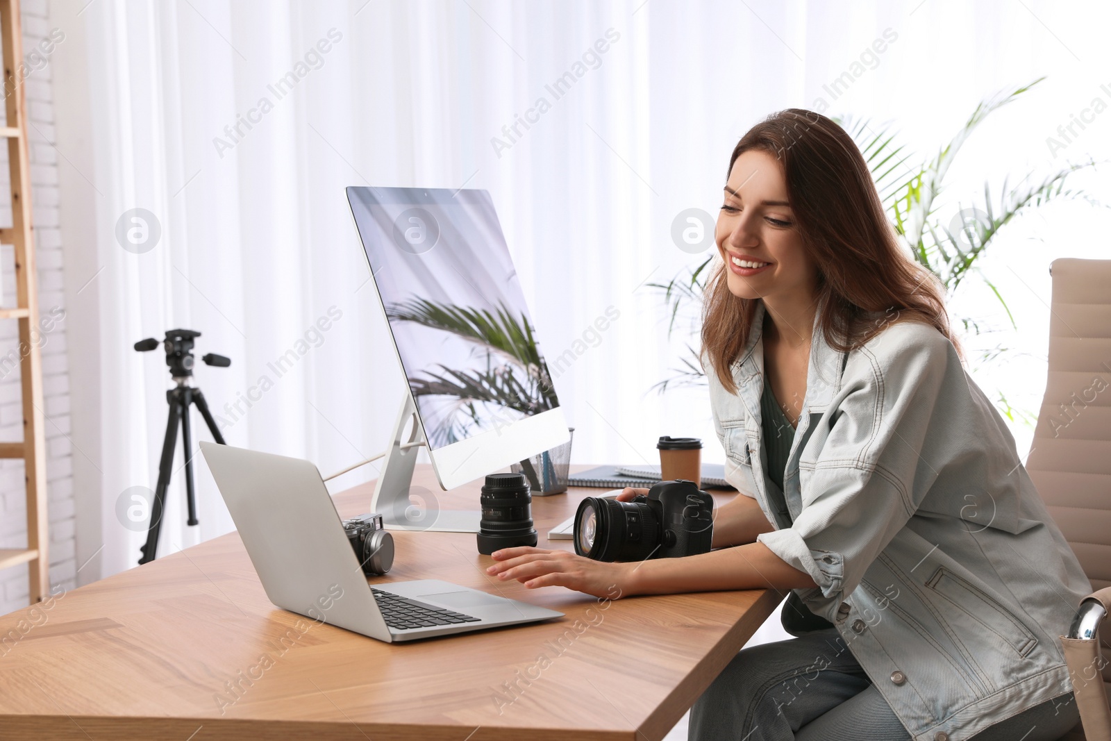 Photo of Professional photographer working at table in office