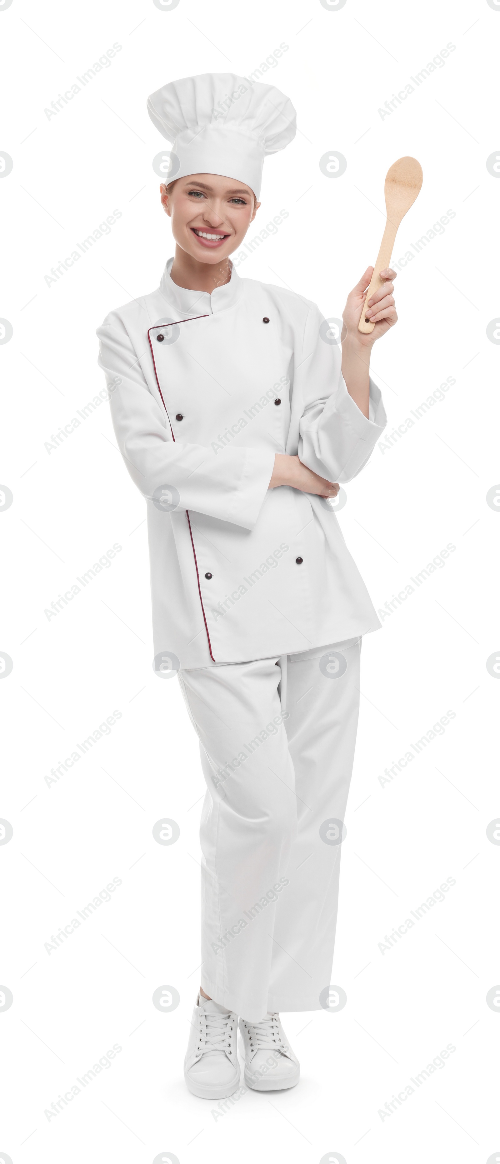 Photo of Happy chef in uniform holding wooden spoon on white background