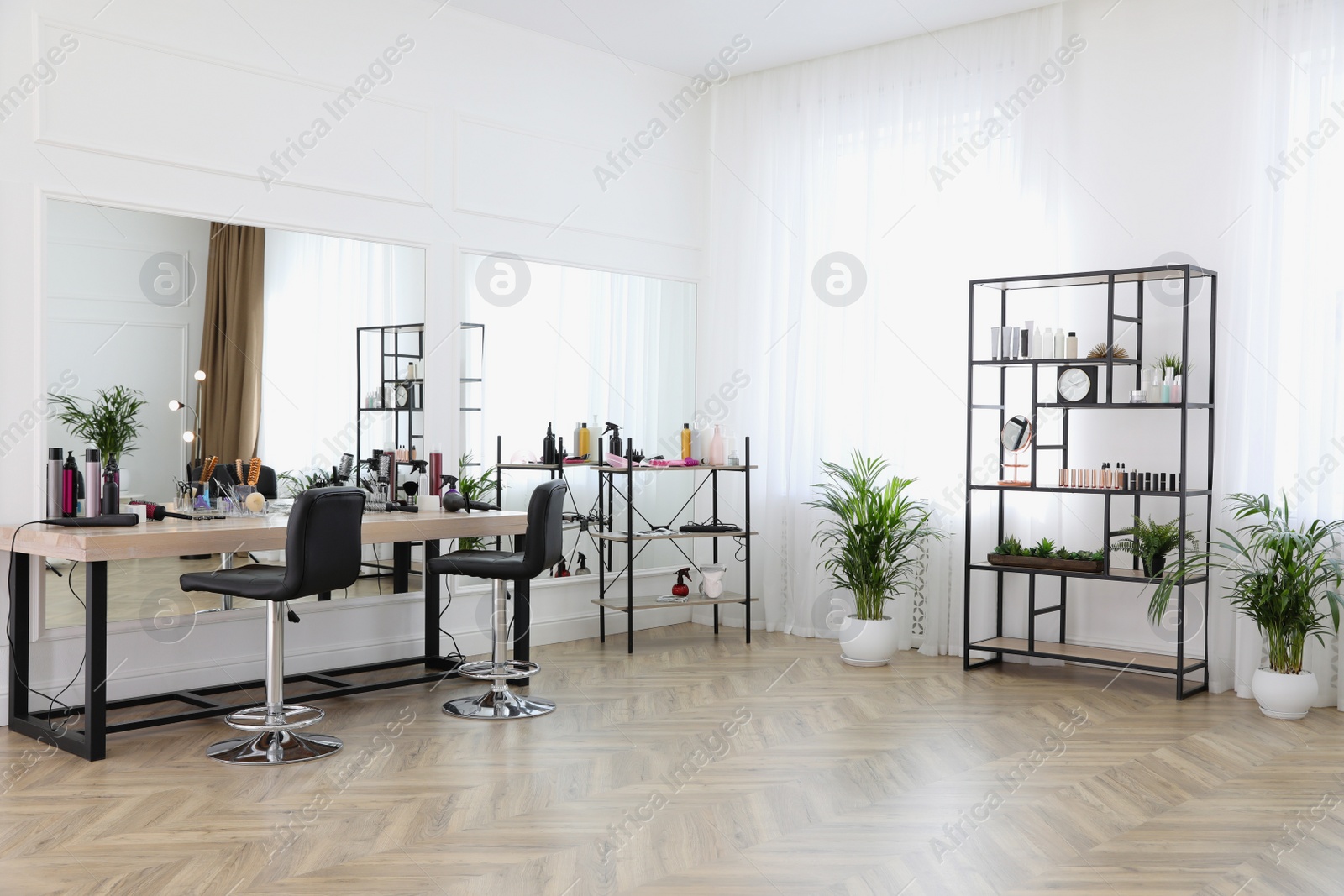 Photo of Stylish beauty salon interior with hairdresser's workplace