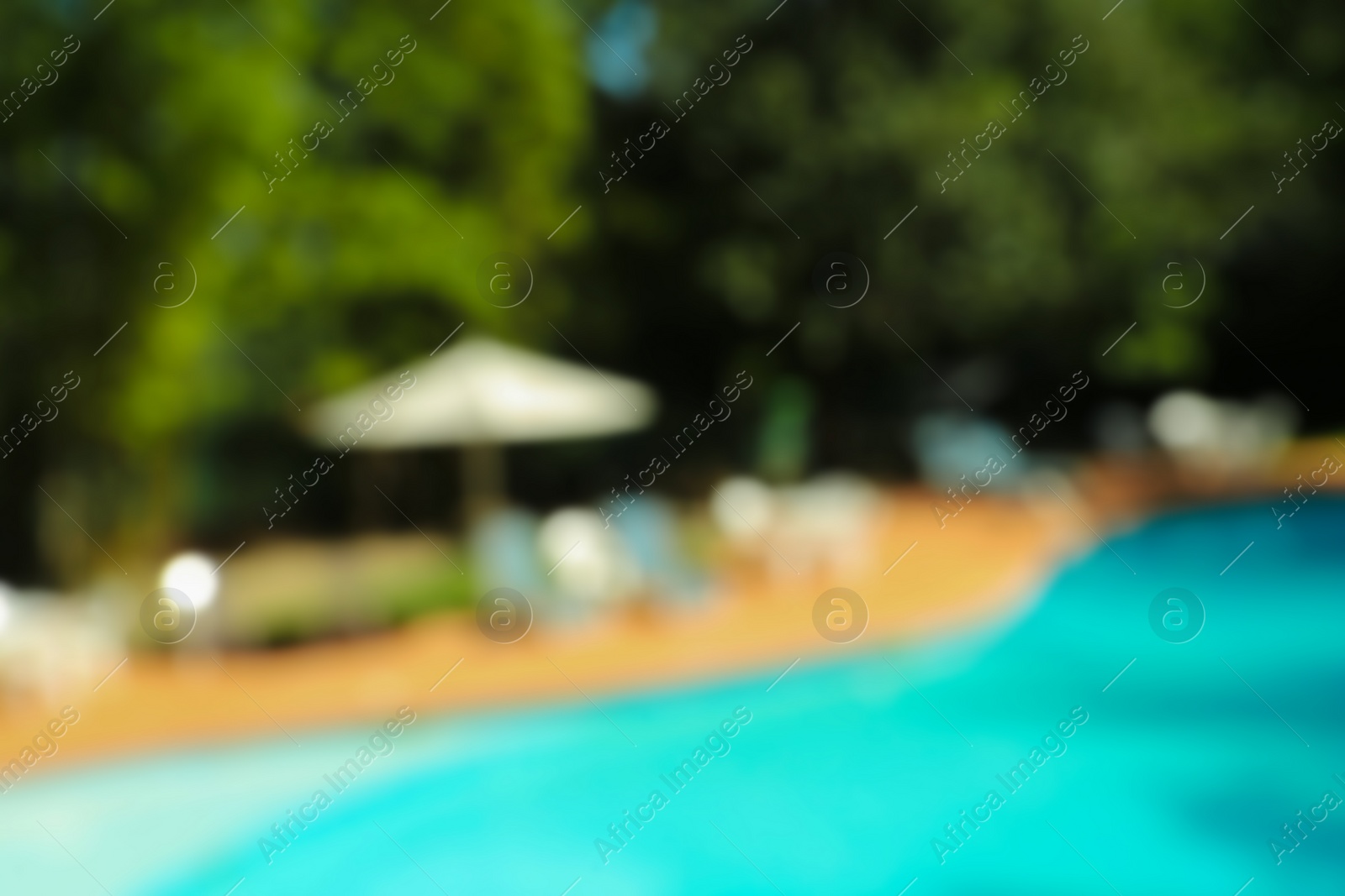 Photo of Blurred view of luxury pool and trees outdoors