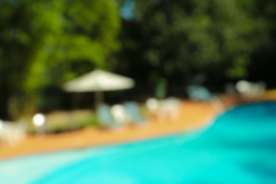 Photo of Blurred view of luxury pool and trees outdoors