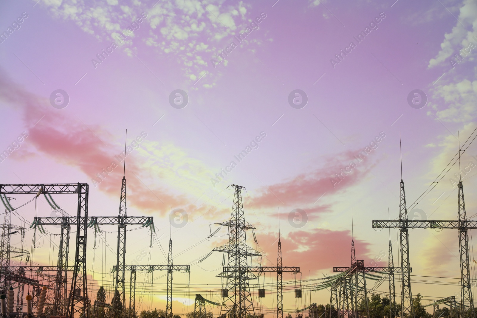 Photo of Modern electrical substation against cloudy sky at sunset