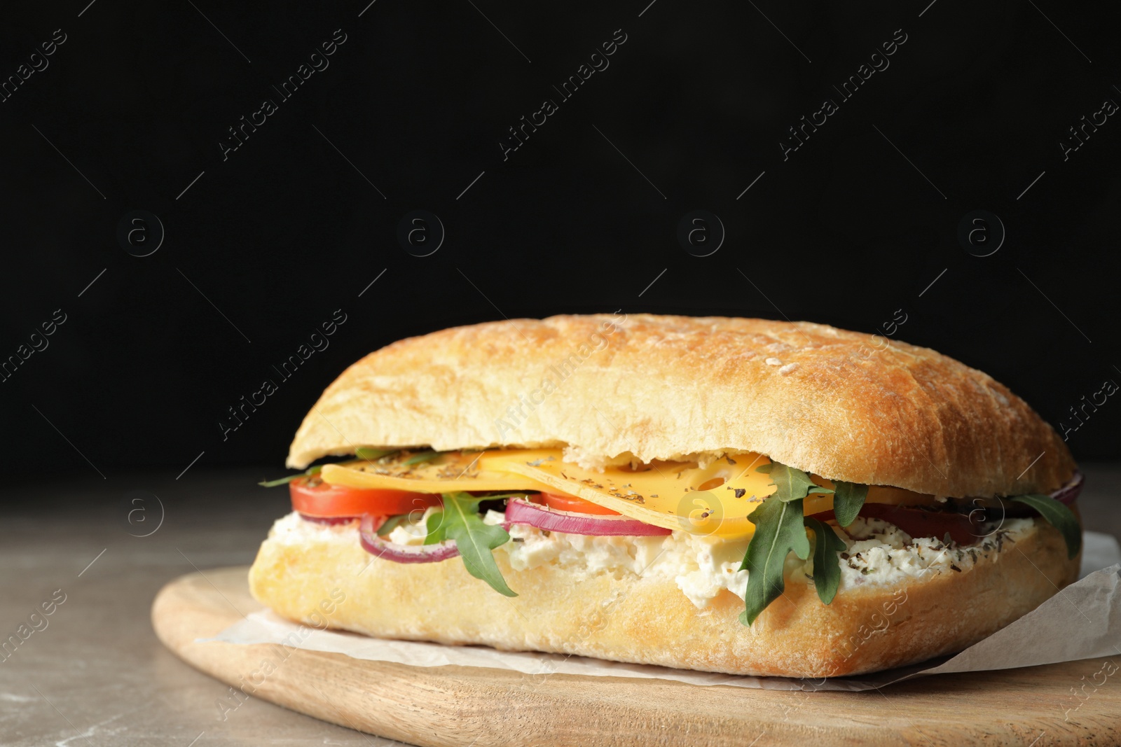 Photo of Delicious sandwich with fresh vegetables and cheese on grey table