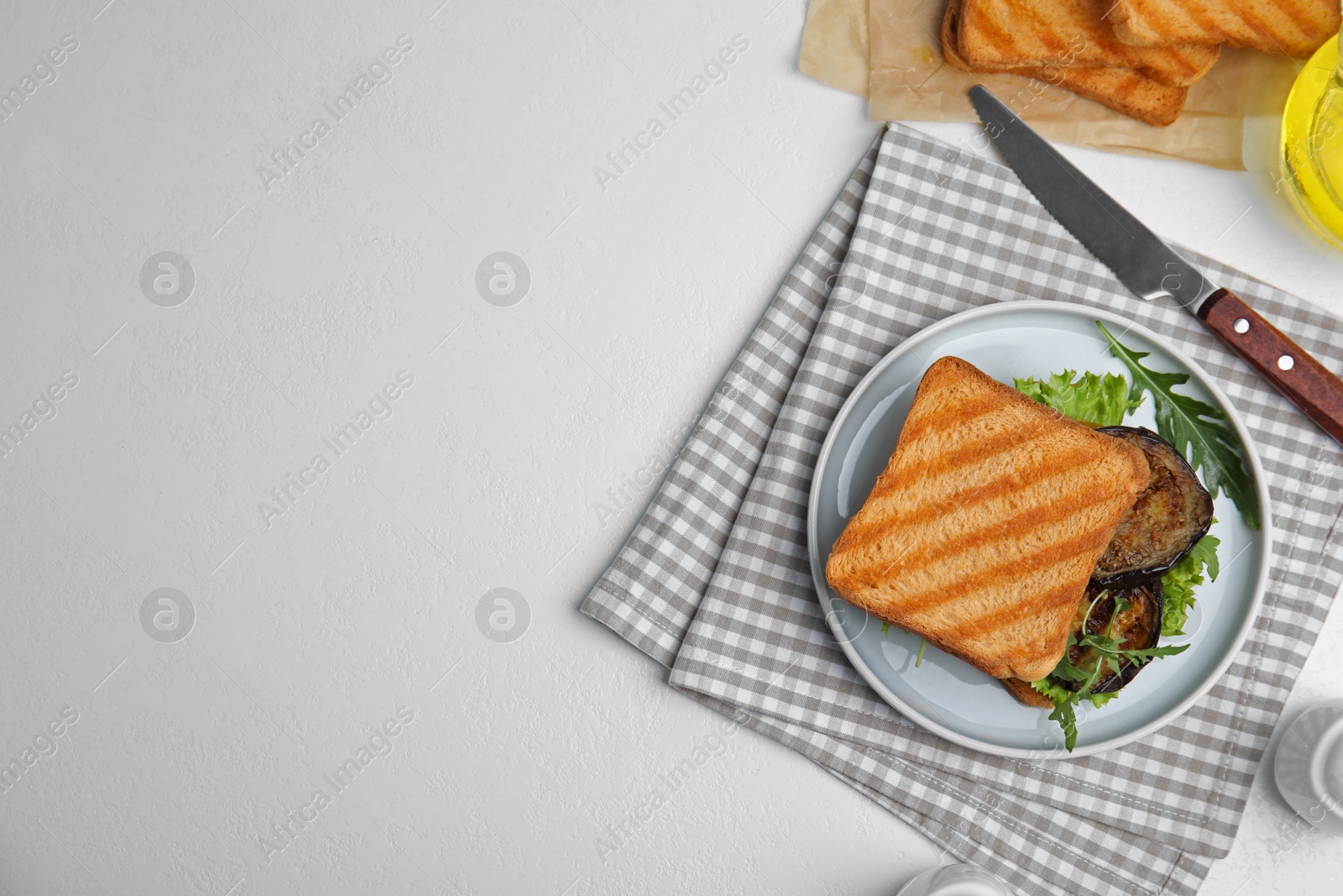 Photo of Delicious eggplant sandwich served on white table, flat lay. Space for text