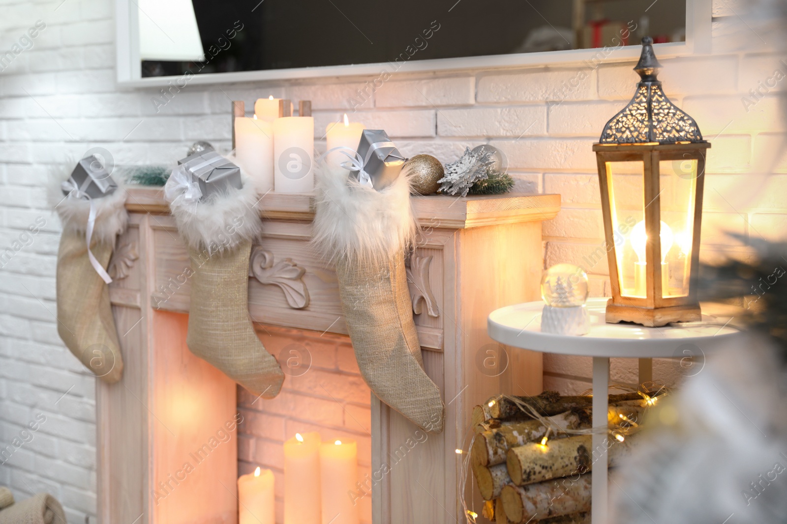 Photo of Santa socks with gifts in room decorated for Christmas