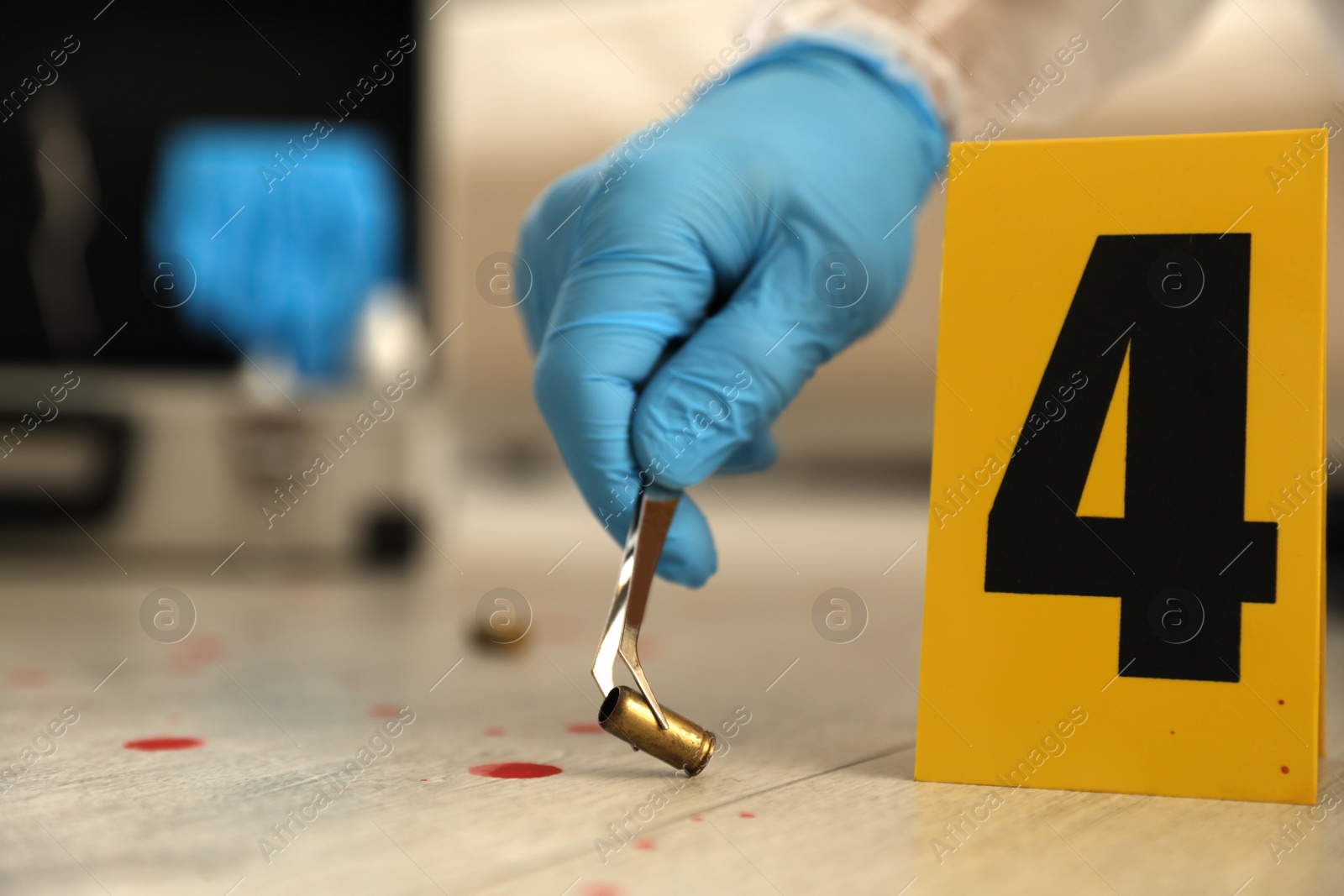 Photo of Investigator in protective gloves working with evidence indoors, closeup. Crime scene