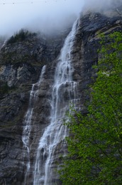 Photo of Low angle view of beautiful waterfall in mountains