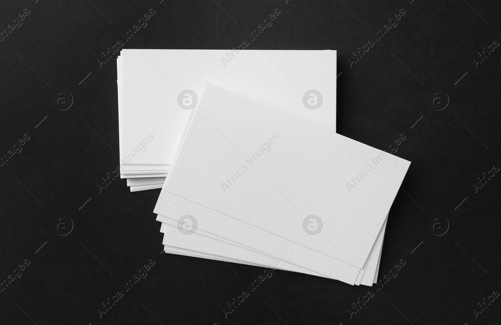 Photo of Blank business cards on black background, top view. Mockup for design