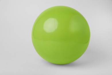 Photo of Light green inflatable beach ball on white background