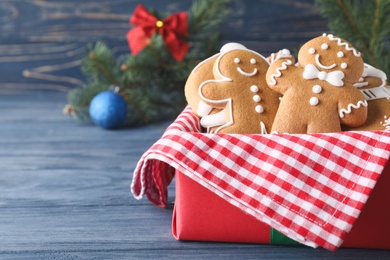 Decorated Christmas cookies on blue wooden table. Space for text