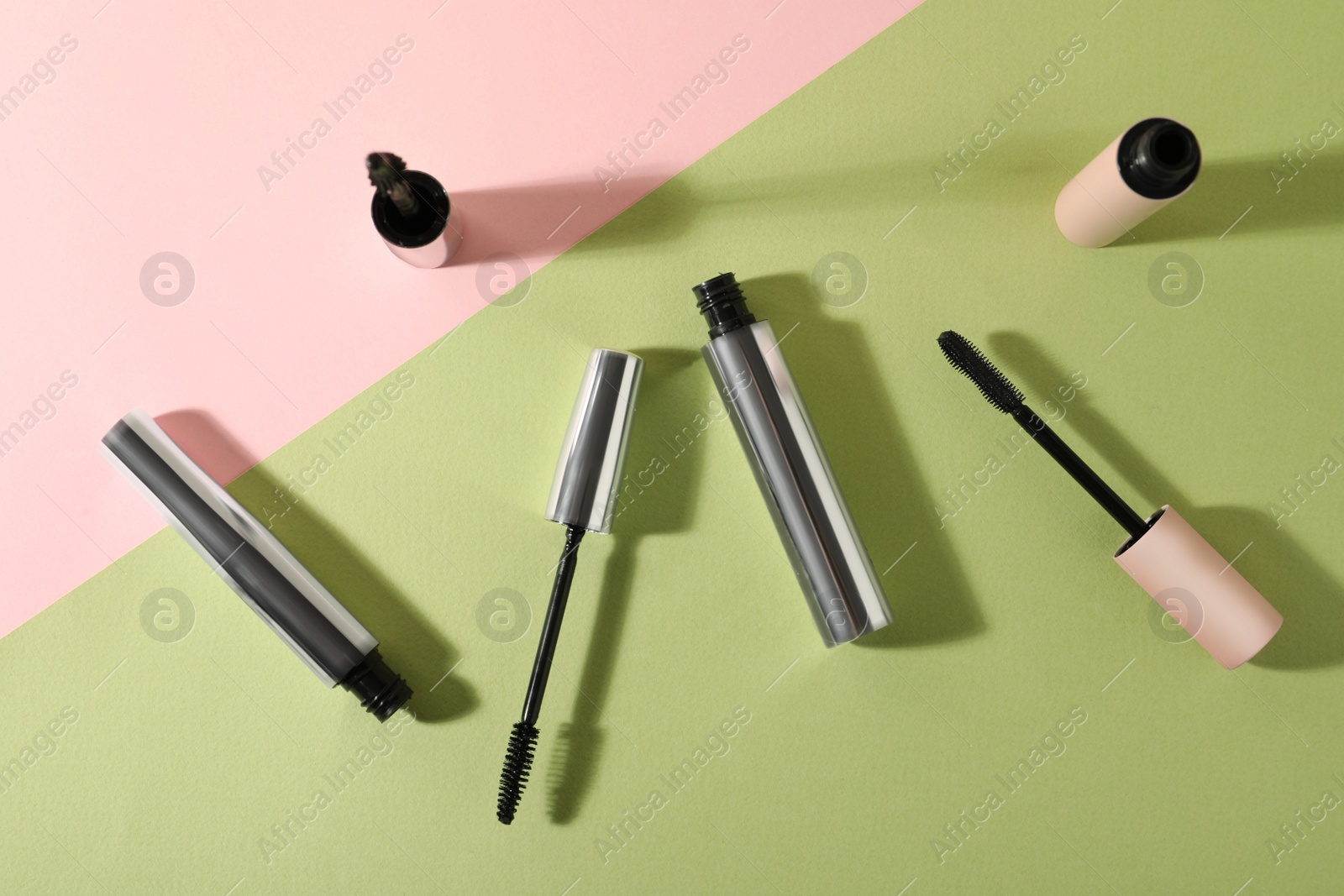 Photo of Different mascaras on color background, flat lay