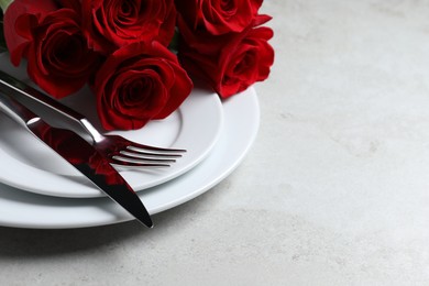 Romantic table setting with rose flowers, space for text