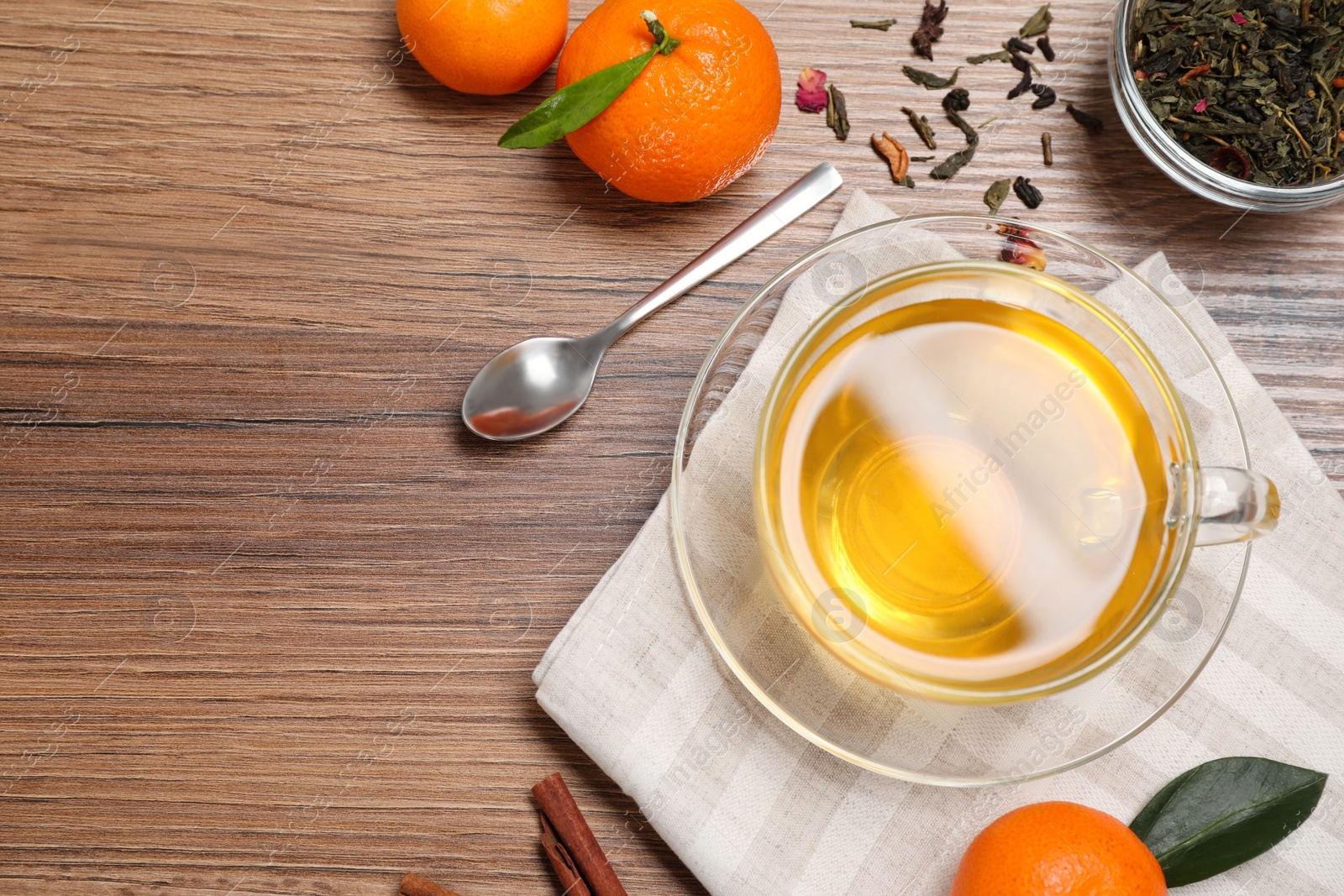 Photo of Flat lay composition with tasty tea in glass cup on wooden table. Space for text