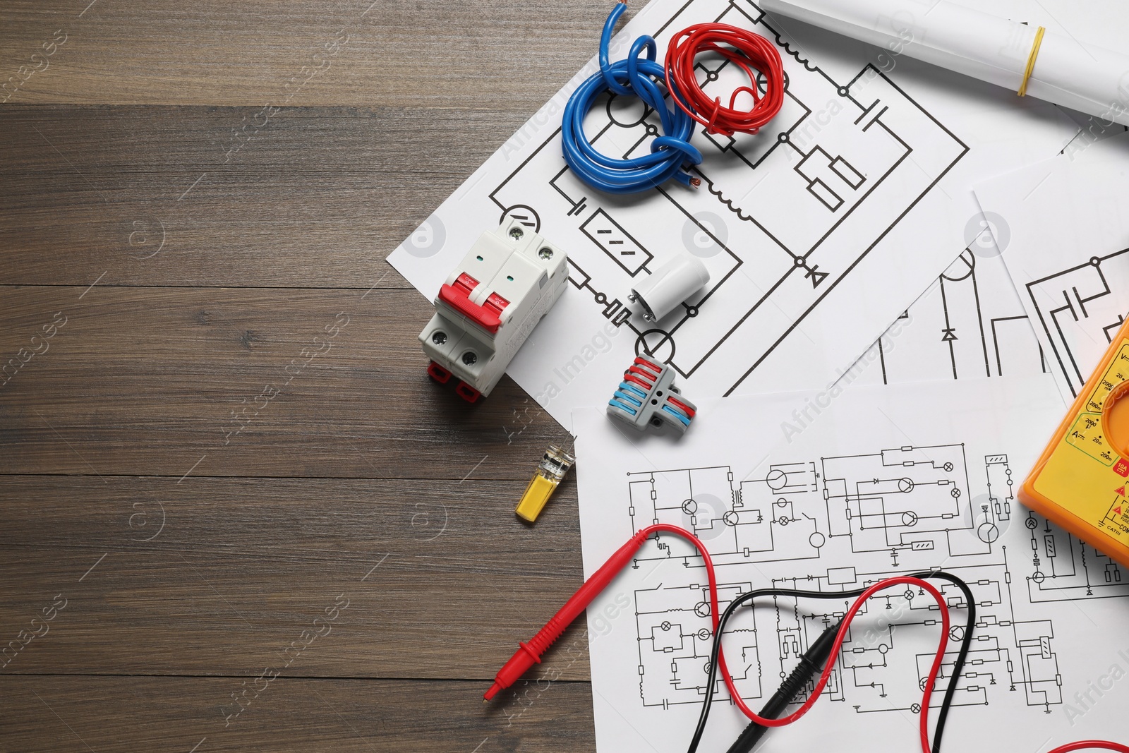 Photo of Flat lay composition with wiring diagrams on wooden table, space for text