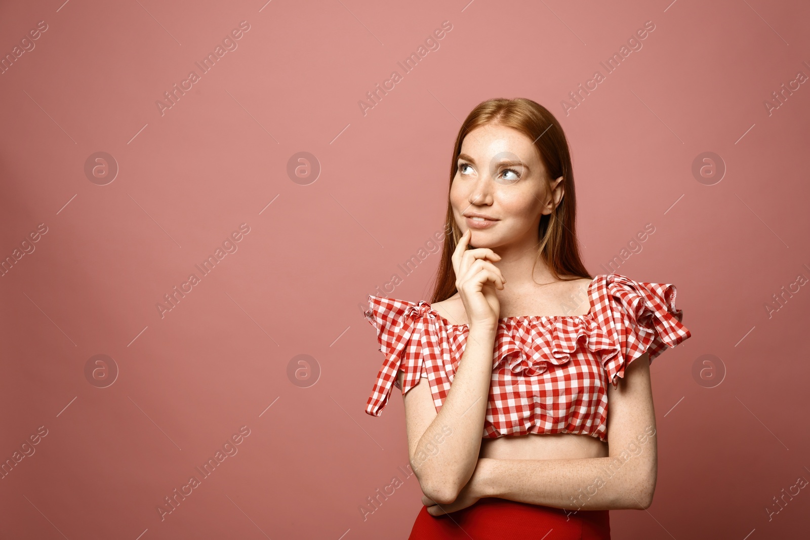 Photo of Portrait of beautiful young woman on pink background, space for text