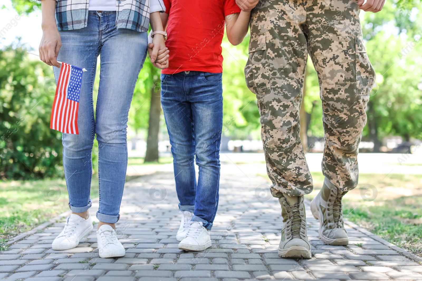 Photo of Male soldier with his family outdoors. Military service