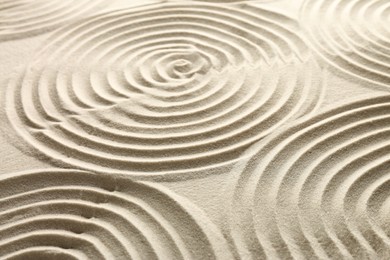 Photo of Beautiful spirals on sand, closeup. Zen garden