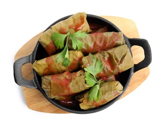 Photo of Delicious stuffed grape leaves with tomato sauce on white background, top view