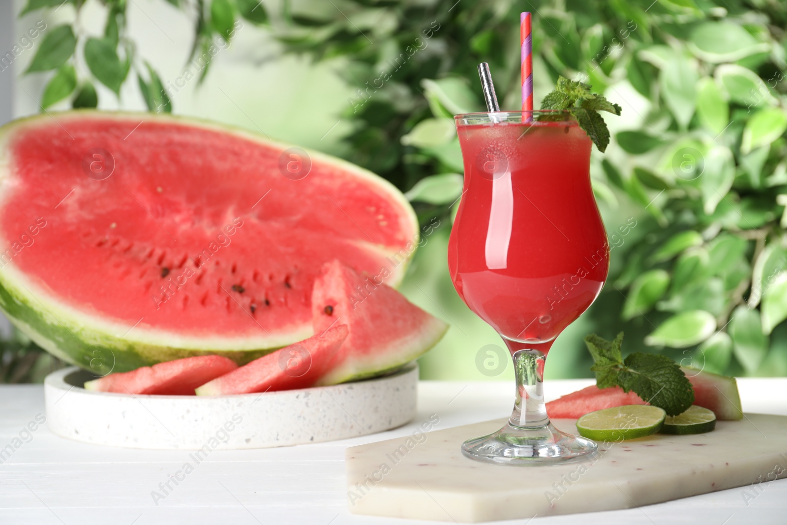 Photo of Delicious fresh watermelon drink on white wooden table