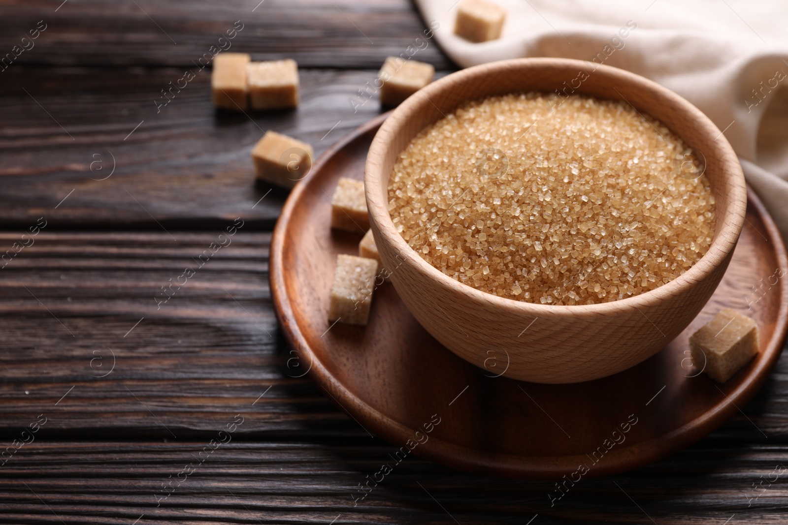 Photo of Brown sugar in bowl on wooden table. Space for text