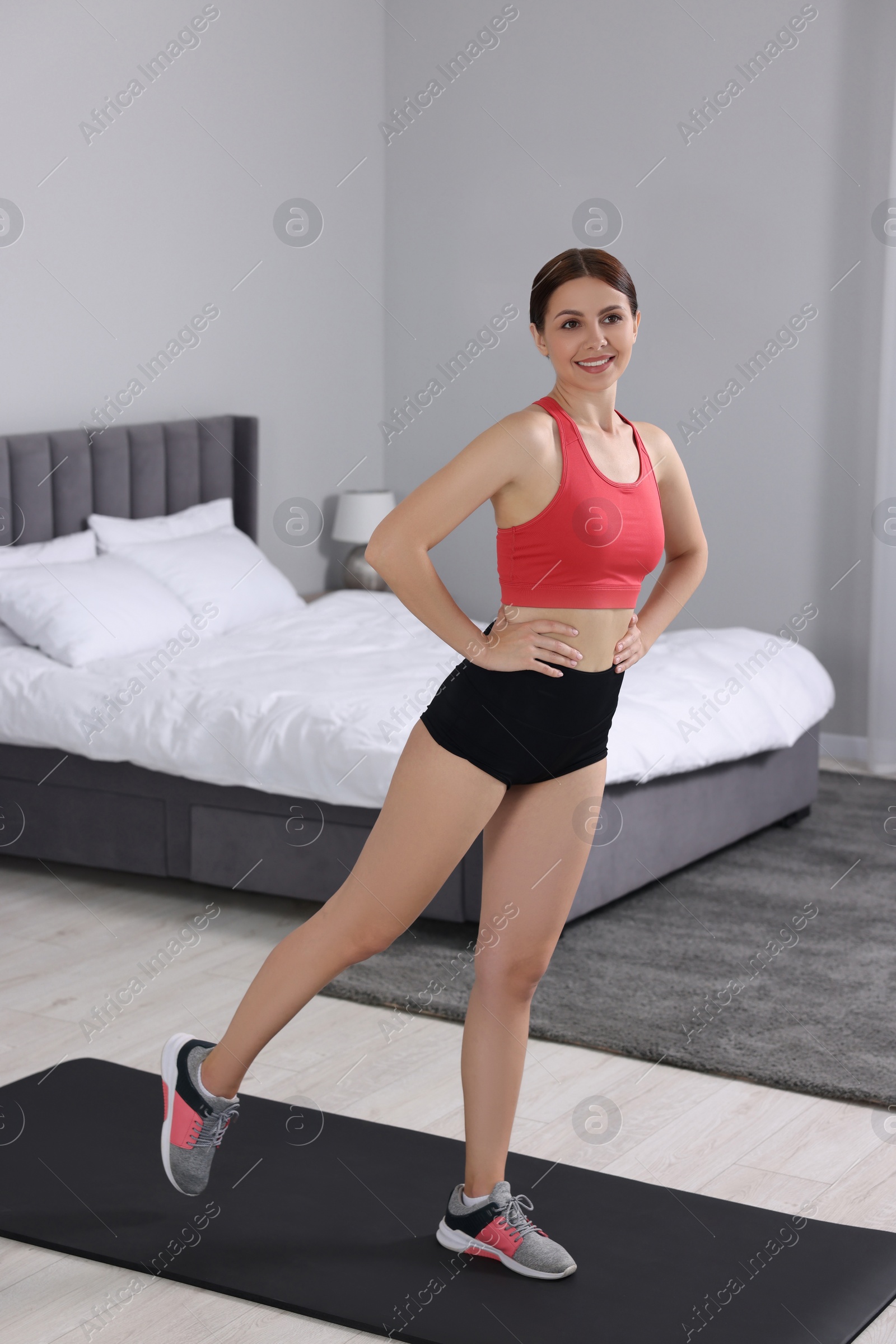 Photo of Happy woman doing morning exercise at home