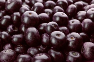 Photo of Fresh ripe acai berries as background, closeup